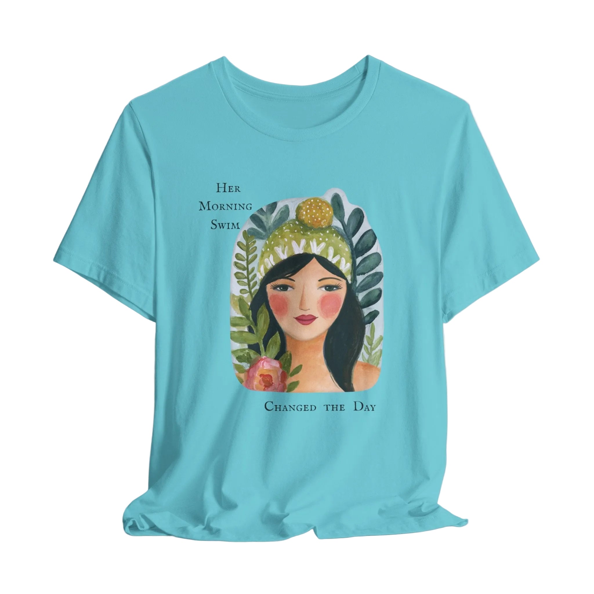 Light blue t-shirt with a graphic of a woman's face surrounded by leaves and flowers, with text above and below the illustration.