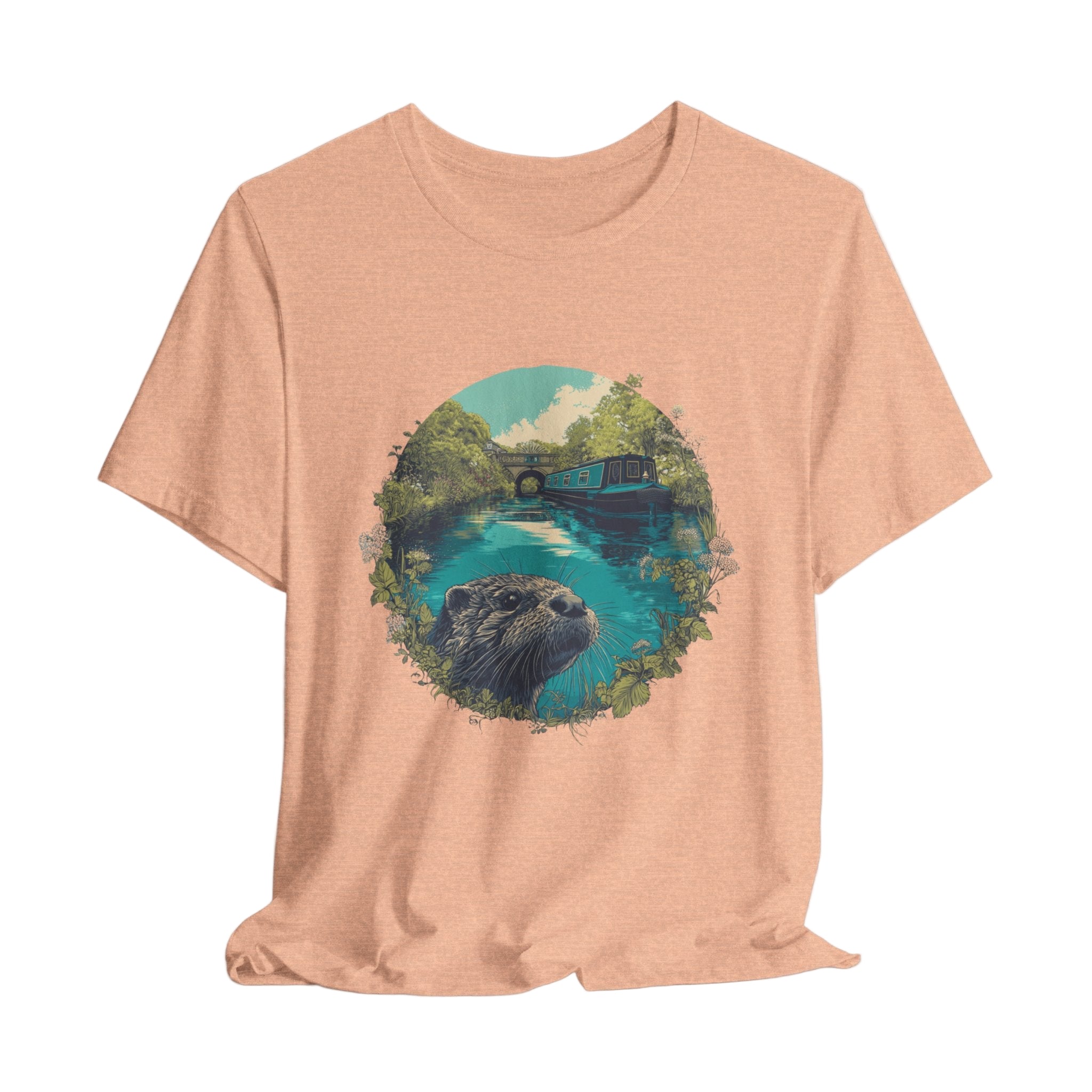 Peach t-shirt with a graphic of an otter and nature scene on a light gray background