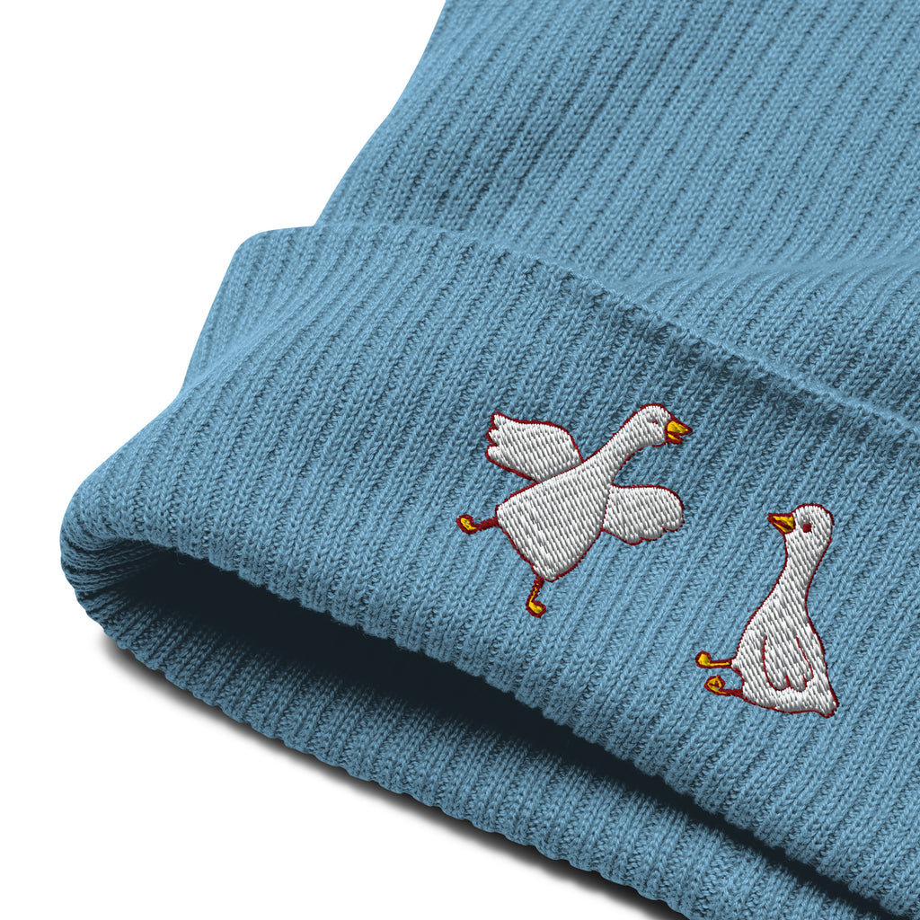 Blue knit beanie with embroidered geese on a white background