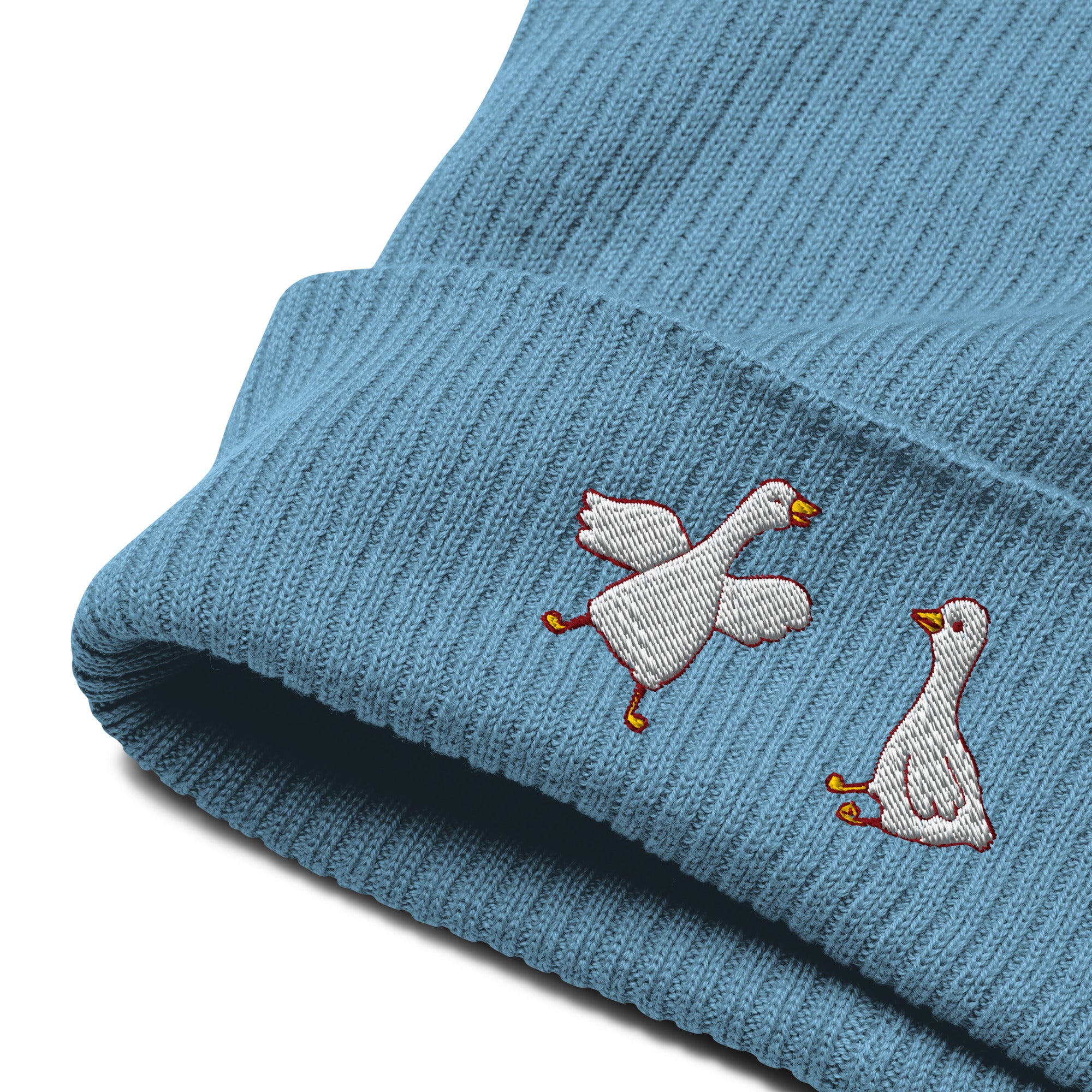 Blue knit beanie with embroidered geese on a white background